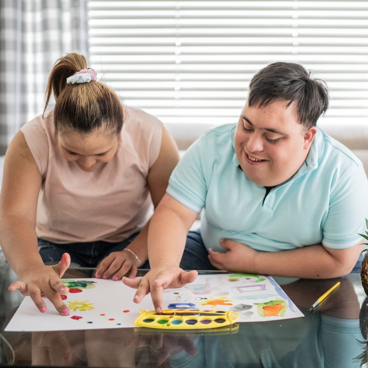 Community members doing a colorful art activity together
